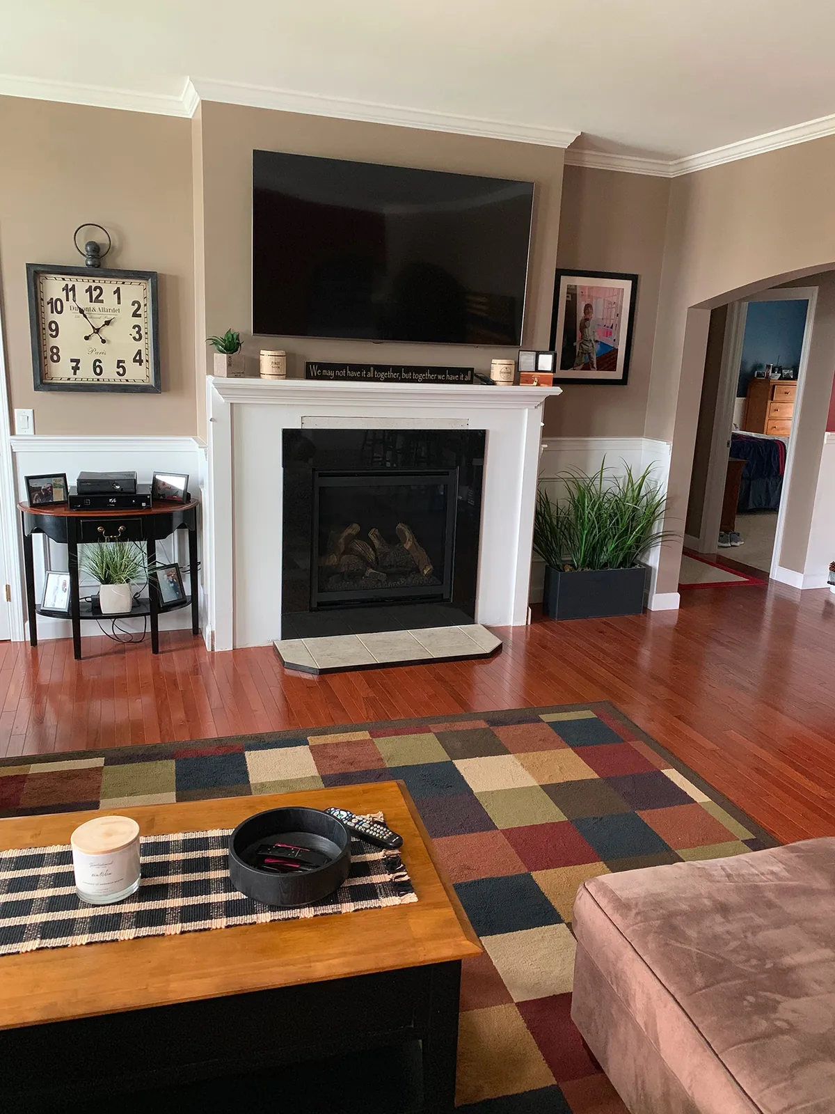 A gas fireplace in a living room beneath a wall-mounted television